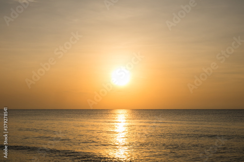 Beautiful golden sunset with blue sky over the horizon on the beach background, Thailand. Tropical twilight colorful sunrise from the landscape sea. Summer vacation concept. © Chaiyaphruek