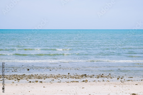 Beautiful sunset with blue sky over the horizon on the beach, Thailand. Tropical colorful sunrise from the sea.