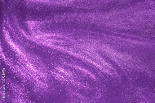 de-focused. Abstract elegant, detailed purple glitter particles flow underwater. Holiday magic shimmering luxury background. Festive sparkles and lights.