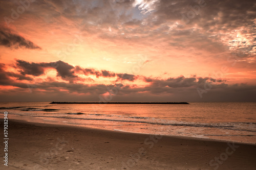 Beautiful golden sunset with blue sky over the horizon on the beach background, Thailand. Tropical twilight colorful sunrise from the landscape sea. Summer ocean vacation concept.