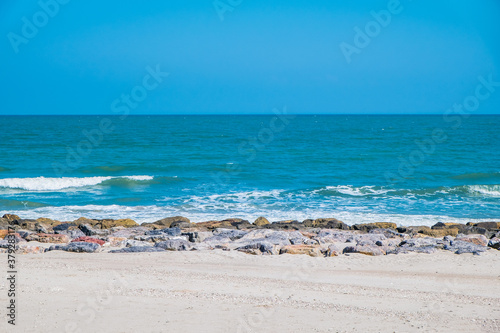 Beautiful golden sunset with blue sky over the horizon on the beach background, Thailand. Tropical twilight colorful sunrise from the landscape sea. Summer vacation concept.