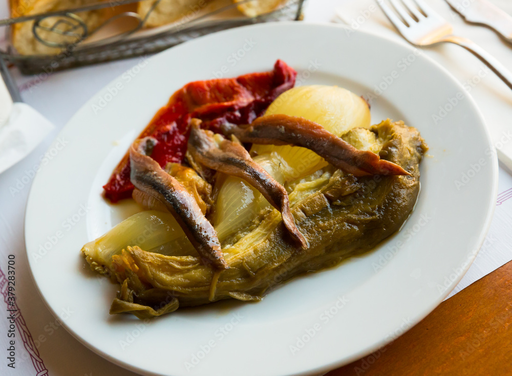 Traditional Catalan escalivada from vegetables baked in oven until tender served with anchovy fillets. National cuisine