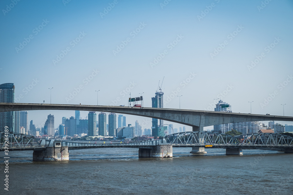 Photo of bridge leading to the downtown of international modern city in the morning crosses the Chao Phraya river, Bangkok, Thailand.