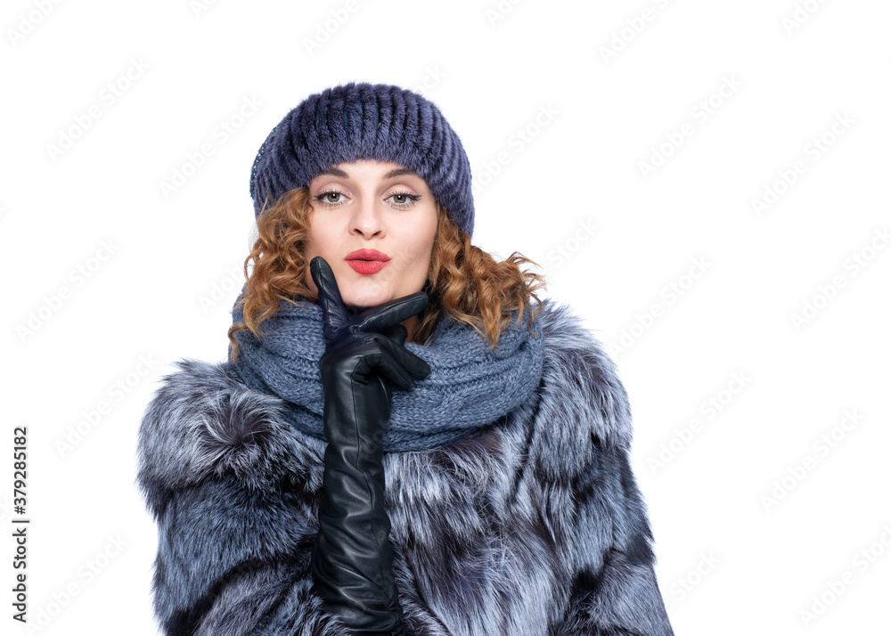 Portrait of a young pretty happy woman in a silver fox fur coat, leather gloves, knitted hat. Isolated on white background. Portrait of a young pretty happy woman in a silver fox fur coat, leather gloves, knitted hat. Isolated on white background.