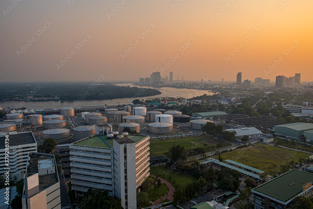 Oil refinery and fuel tank rooftop view at sunset with Chao Phraya River, Bangkok, Thailand. Oil refinery and fuel tank rooftop view at sunset with Chao Phraya River, Bangkok, Thailand.
