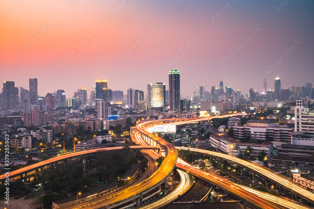Fototapeta premium Aerial view of the modern buildings and skyscrapers at sunset of Bangkok City, Thailand.