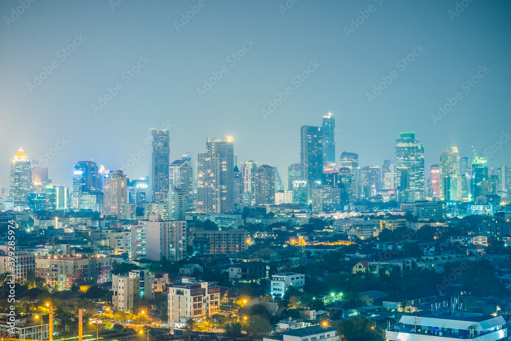 Aerial view of the modern buildings and skyscrapers at night of Bangkok City, Thailand.