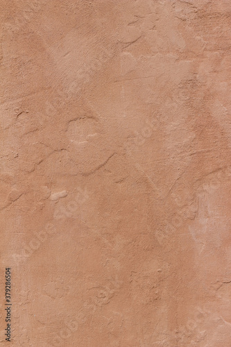 Photography Abstract background of an exterior reddish brown adobe style textured wall surfa