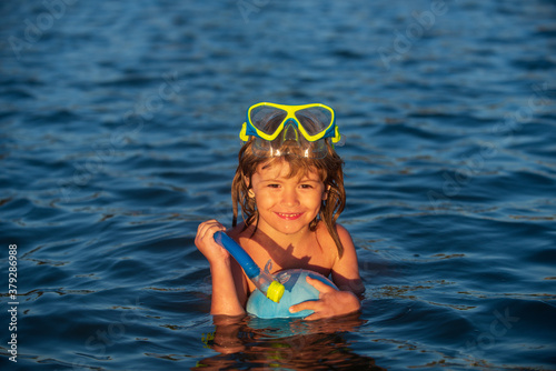 Kid boy wearing snorkel mask in sea or ocean.