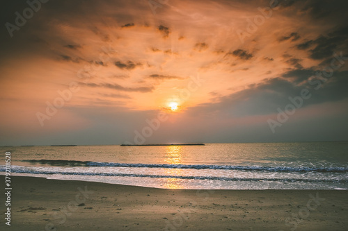 Beautiful golden sunset with blue sky over the horizon on the beach background  Thailand. Tropical twilight colorful sunrise from the landscape sea. Summer ocean vacation concept.