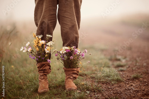 garden flowers in boots in autumn season. photo