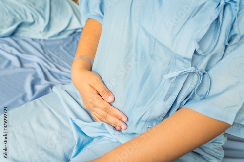 Cropped shot of young woman experiencing stomach pain.