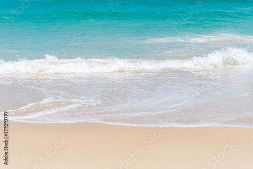 Tropical nature clean beach and white sand in summer with sun light blue sky and bokeh.