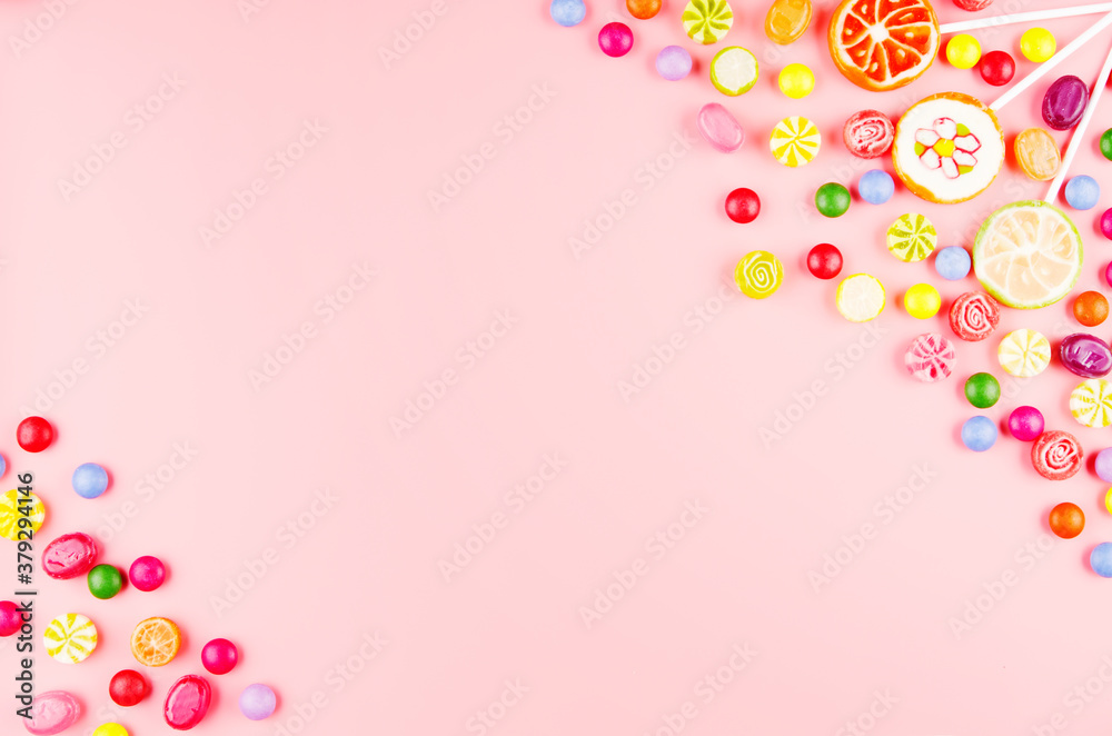 Flat lay view at sweet background of different type color and taste candies on pink. Space for text Flat lay view at sweet background of different type color and taste candies on pink. Space for text
