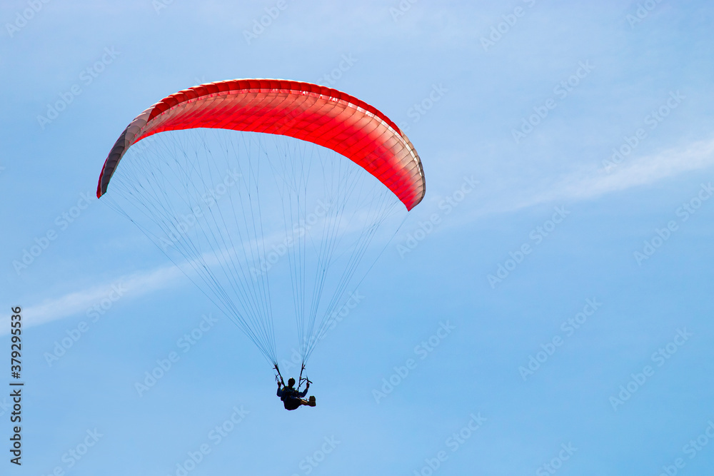 parachute paraglider in flight against the background of a clear blue sky parachute paraglider in flight against the background of a clear blue sky