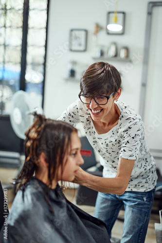 Hairdresser cutting hair in a salon.