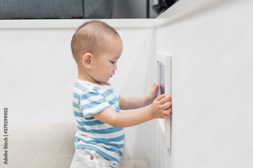 A baby boy of one and a half years old is playing in the room A baby boy of one and a half years old is playing in the room