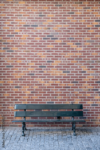 Brick wall and park bench.