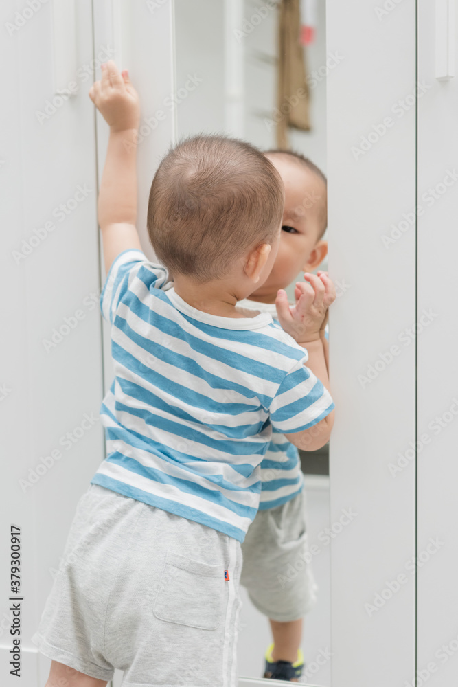 A baby boy of one and a half years old is playing in the room A baby boy of one and a half years old is playing in the room