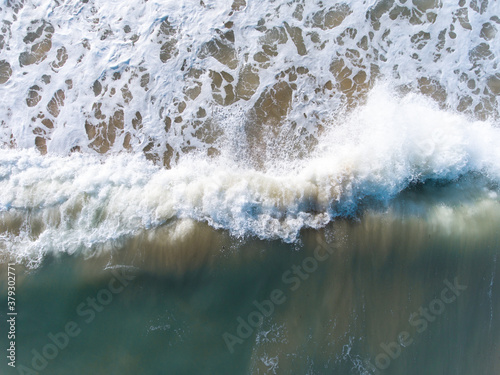 Aerial view of blue sea, waves and beach