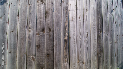 Wooden surface made of old unpainted boards. A fragment of a plank wall or fence. © Olga