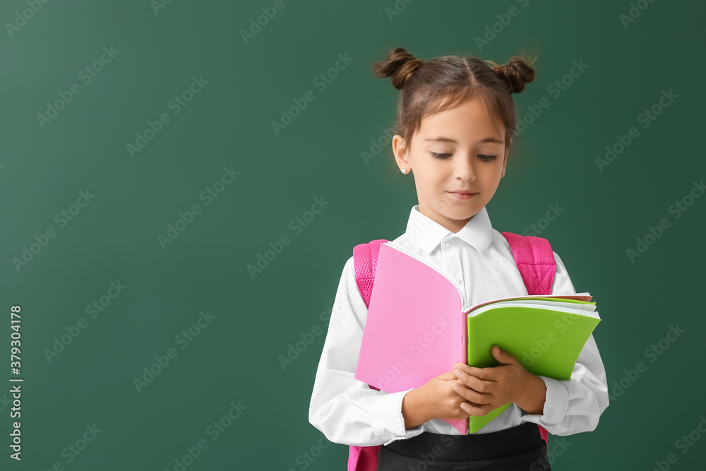 Little schoolgirl with copybooks on color background Little schoolgirl with copybooks on color background