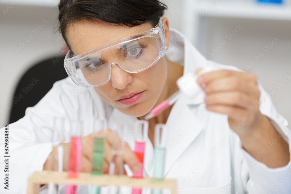 bulb with liquid pipette and woman with glasses bulb with liquid pipette and woman with glasses