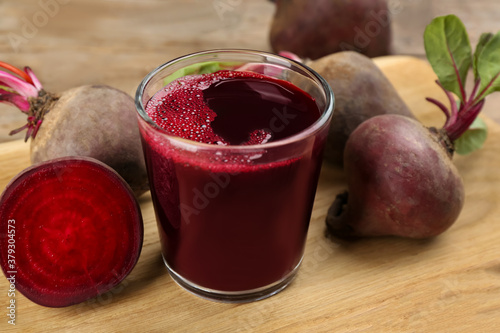 Freshly made beet juice on wooden table