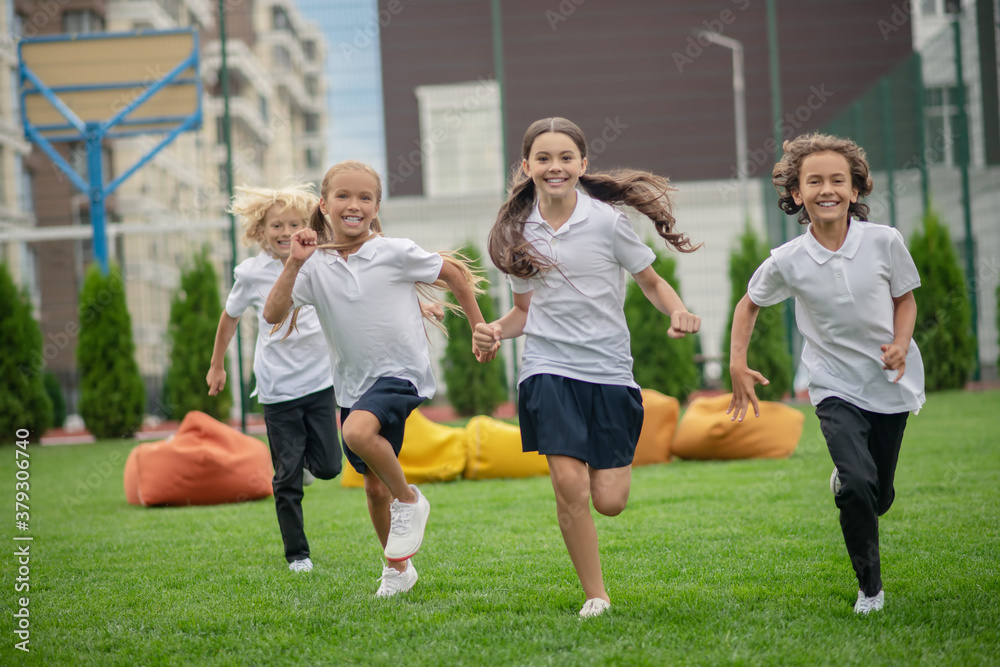 Group of children running and looking happy