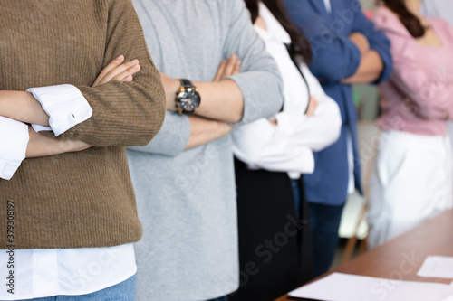 Business asian man and woman stand and cross arm in the office.