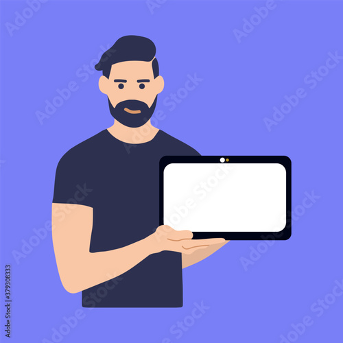 Young man holding a tablet computer and pointing index finger towards blank screen. A place to post your advertisement or other information. Advertising.