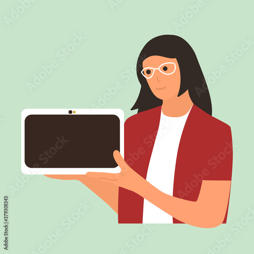 Young woman holding a tablet computer and pointing index finger towards blank screen. A place to post your advertisement or other information. Advertising.