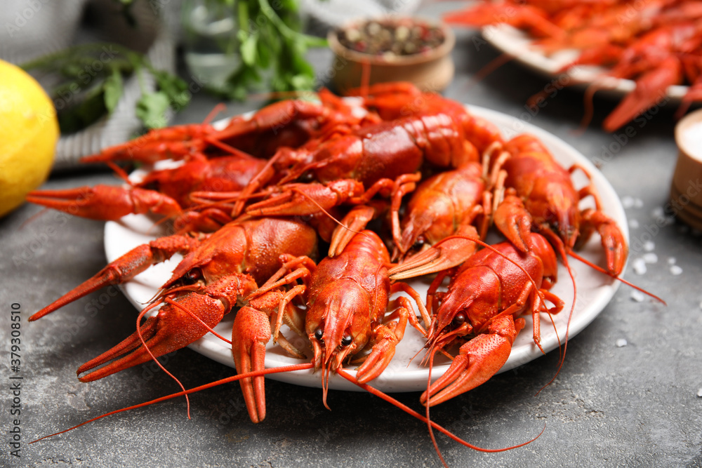 Delicious red boiled crayfishes on grey table, closeup Delicious red boiled crayfishes on grey table, closeup