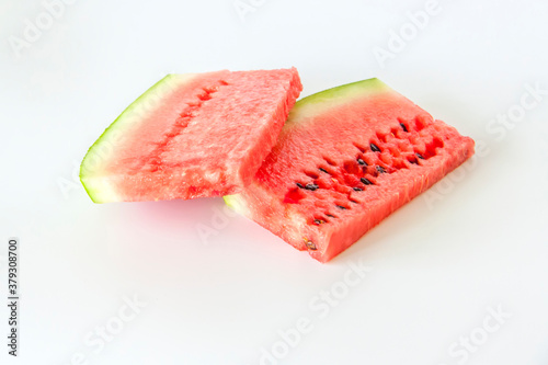 Red ripe watermelon sliced on a white background.