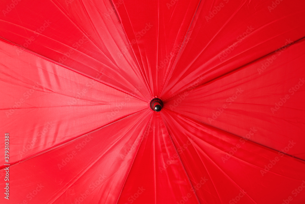 Bright red umbrella as background, closeup view