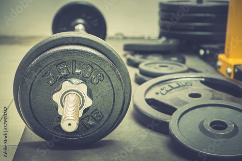 Barbell weight at health club, Fitness equipment in gym room, Old dumbbell.