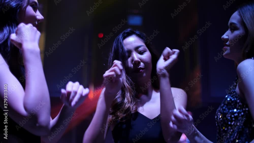 Young people are having fun dancing in club. Nightlife and disco concept.