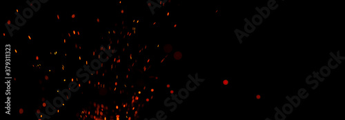 Flying smeared sparks on a black background. Banner with copy space for text.