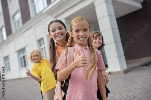 Schoolchildren playing in school yard and feeling cheerful