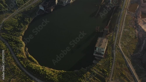 An aerial view of the flooded mine. A man-made disaster. The aftermath of the accident.  Failure in the earth's surface, destroyed industrial buildings. The city of Berezniki, Russia, Uralkali. photo