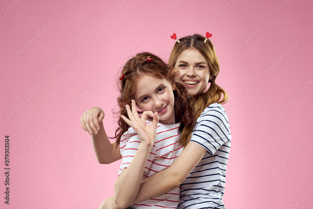 Cheerful mom and daughter joy lifestyle studio pink background family Cheerful mom and daughter joy lifestyle studio pink background family