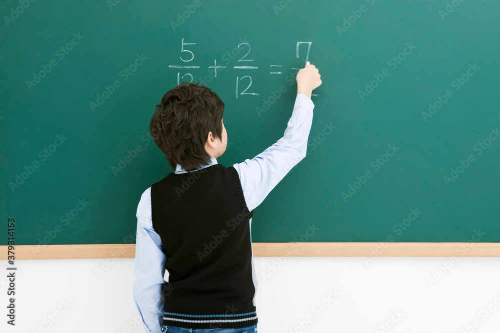 boy in front of blackboard boy in front of blackboard