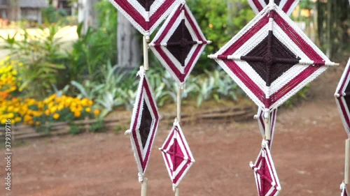 Close up. Decoration from fabric handmade hunging in tread and waving on wind. Craft design decoration on string outdoor.