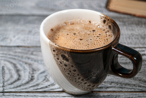 Cup of coffee on the table with beautiful foam