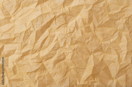 The texture of a crumpled yellow-gold disposable textile napkin.