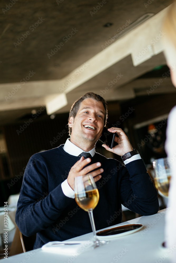 Handsome businessman dressed in the suit drinking wine. Businessman enjoying in the restaurant. Handsome businessman dressed in the suit drinking wine. Businessman enjoying in the restaurant.