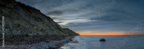 View of sunset on the steep coast of the Baltic Sea.Panorama view of wild romantic coastal cliff landscape at the Baltic Sea at the Stohl, Schwedeneck, Schleswig-Holstein, Germany