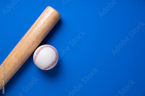 Photography baseball and baseball bat on blue table background, close up
