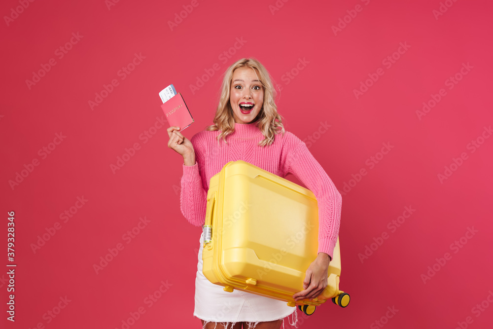 Image of excited blonde woman posing with passport and suitcase Image of excited blonde woman posing with passport and suitcase