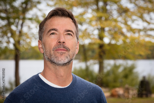 Handsome Mature Man lost in thought. Looking the sky. He is a dreamer.